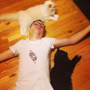 The Canadian One lies down and the cat just come to him...